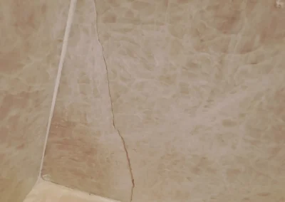After photo of a shower wall crack repair with the damaged area restored and blended into the surface