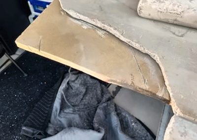 Severely broken travertine table before repair by Son of MT Repairs
