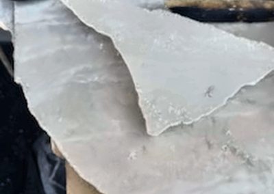 Damaged edge of travertine table before professional repair