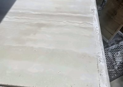 Restored travertine table surface after professional repair